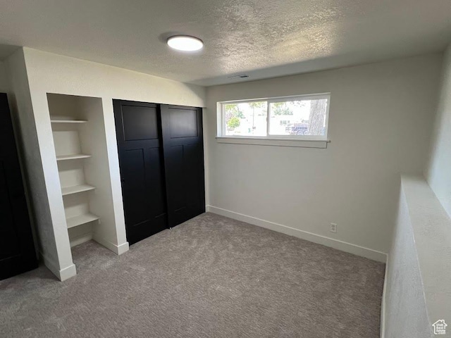 1569 E Boysenberry Cir S, Sandy, UT 84093 - unfurnished bedroom with light colored carpet, a textured ceiling, and a closet
