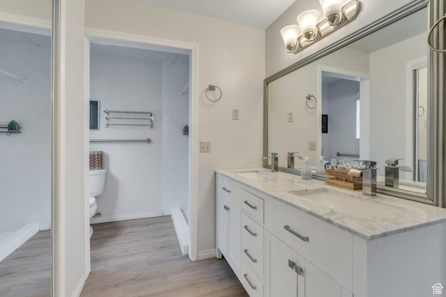 12012 S Hidden Valley Club Dr, Sandy, UT 84092 - bathroom with double vanity, wood finished floors, and a tile shower