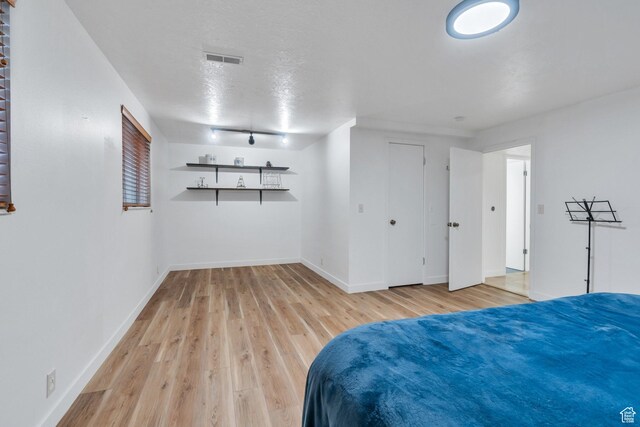12012 S Hidden Valley Club Dr, Sandy, UT 84092 - bedroom with light wood finished floors and a textured ceiling