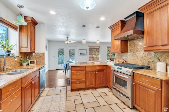 12012 S Hidden Valley Club Dr, Sandy, UT 84092 - kitchen featuring appliances with stainless steel finishes, custom exhaust hood, a peninsula, brown cabinets, and recessed lighting