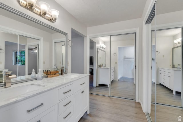 12012 S Hidden Valley Club Dr, Sandy, UT 84092 - bathroom with double vanity and wood finished floors