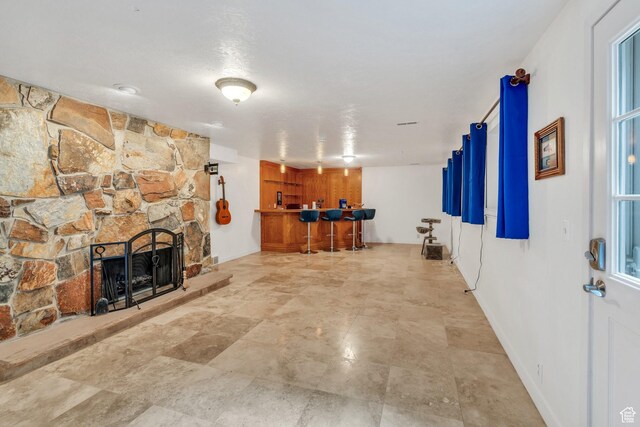 12012 S Hidden Valley Club Dr, Sandy, UT 84092 - living room featuring bar with sink and a stone fireplace