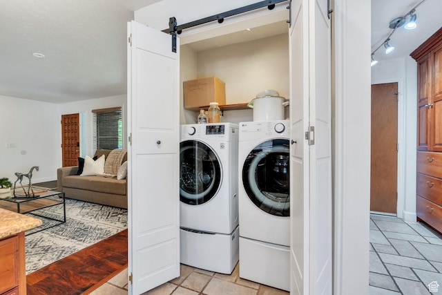 12012 S Hidden Valley Club Dr, Sandy, UT 84092 - laundry room with independent washer and dryer, a barn door, and stone tile flooring
