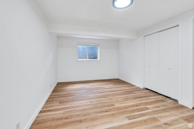 12012 S Hidden Valley Club Dr, Sandy, UT 84092 - unfurnished bedroom featuring a closet and light wood-style flooring
