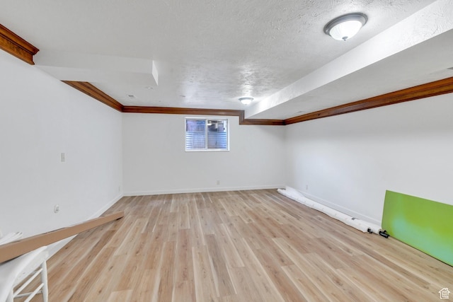 12012 S Hidden Valley Club Dr, Sandy, UT 84092 - basement with light wood finished floors, ornamental molding, and a textured ceiling