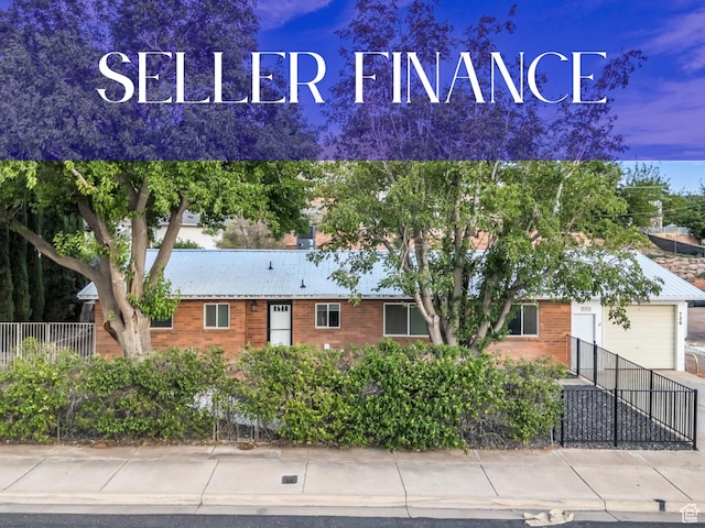726 N Valley View Dr E, St George, UT 84770 - view of front of home featuring an attached garage and a metal roof