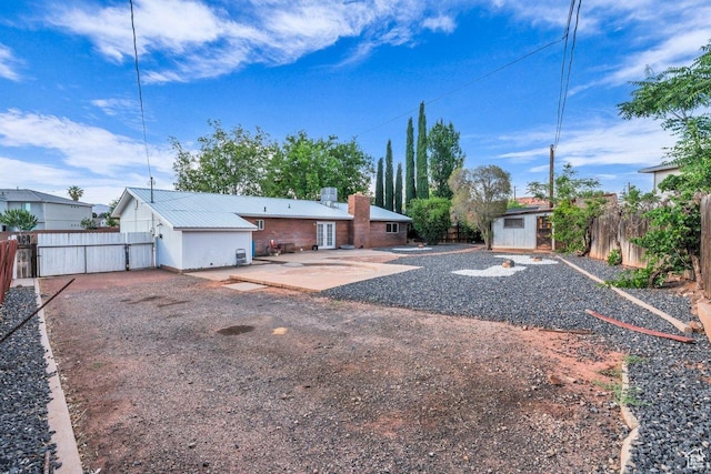 726 N Valley View Dr E, St George, UT 84770 - rear view of house with a patio, a shed, a fenced backyard, and a chimney