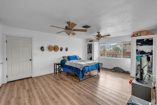 726 N Valley View Dr E, St George, UT 84770 - bedroom with light wood-style flooring, a textured ceiling, and ceiling fan