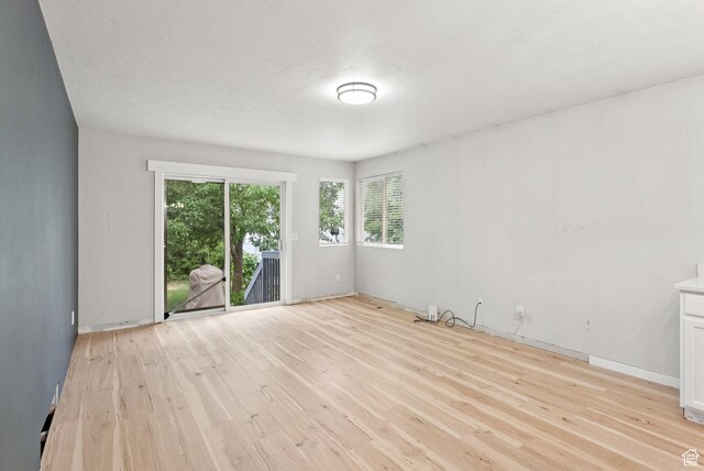 1212 Pinehurst Cir, Farmington, UT 84025 - empty room featuring light wood-style flooring and a textured ceiling