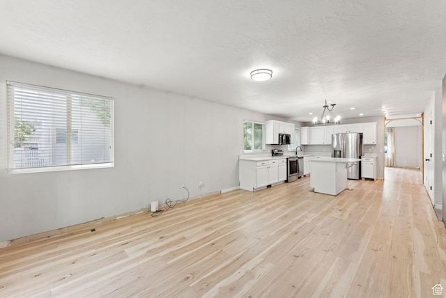 1212 Pinehurst Cir, Farmington, UT 84025 - unfurnished living room with a chandelier and light wood finished floors