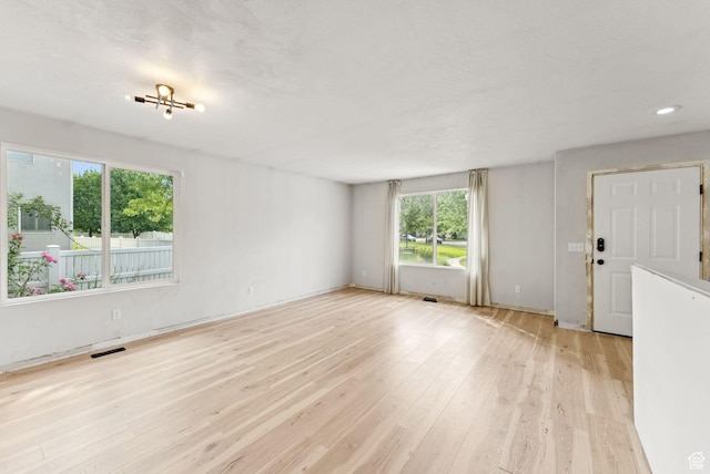 1212 Pinehurst Cir, Farmington, UT 84025 - unfurnished living room with plenty of natural light, light wood-style floors, and recessed lighting