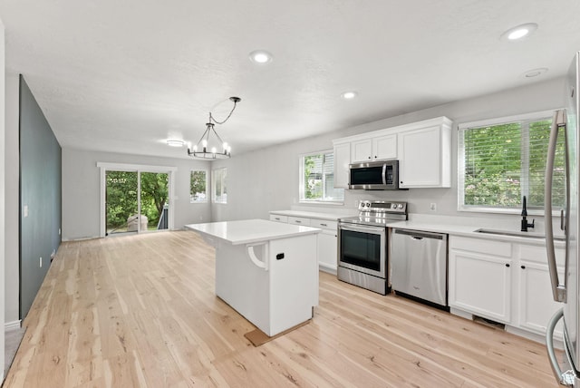 1212 Pinehurst Cir, Farmington, UT 84025 - kitchen featuring appliances with stainless steel finishes, light wood-type flooring, light countertops, white cabinets, and recessed lighting