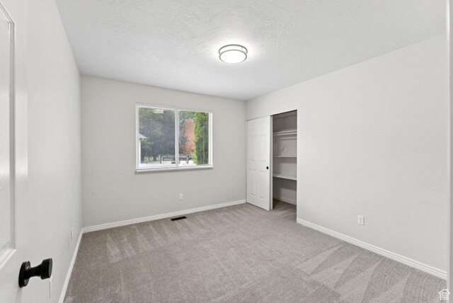 1212 Pinehurst Cir, Farmington, UT 84025 - unfurnished bedroom with carpet floors, a textured ceiling, and a closet