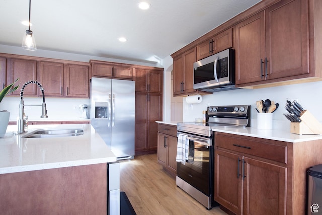 922 Olson Dr N, Saratoga Springs, UT 84045 - kitchen featuring stainless steel appliances, light wood-style flooring, recessed lighting, decorative light fixtures, and brown cabinetry