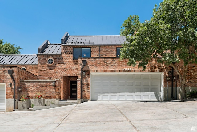1537 N Sweetwater Ln, Farmington, UT 84025 - view of front facade with a standing seam roof, driveway, a metal roof, brick siding, and a garage