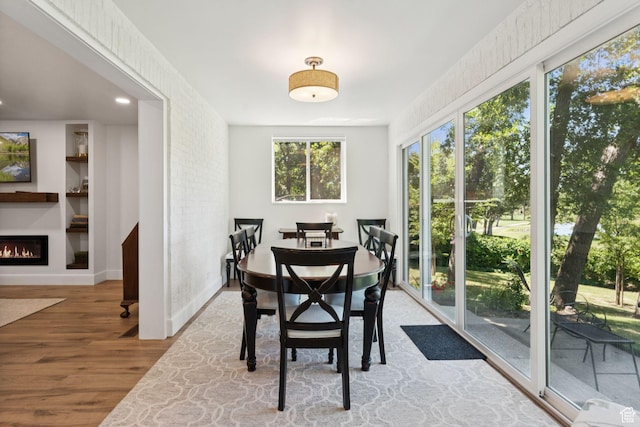 1537 N Sweetwater Ln, Farmington, UT 84025 - dining room with wood finished floors and a warm lit fireplace
