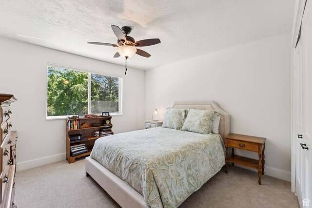 1537 N Sweetwater Ln, Farmington, UT 84025 - bedroom featuring light carpet, a closet, a ceiling fan, and a textured ceiling