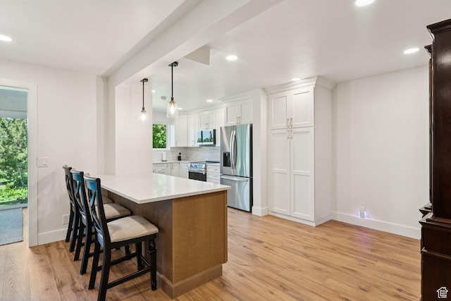1537 N Sweetwater Ln, Farmington, UT 84025 - kitchen with appliances with stainless steel finishes, healthy amount of natural light, white cabinets, light countertops, and recessed lighting