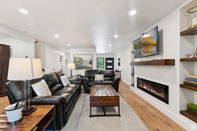 1537 N Sweetwater Ln, Farmington, UT 84025 - living area featuring light wood finished floors, a glass covered fireplace, and recessed lighting