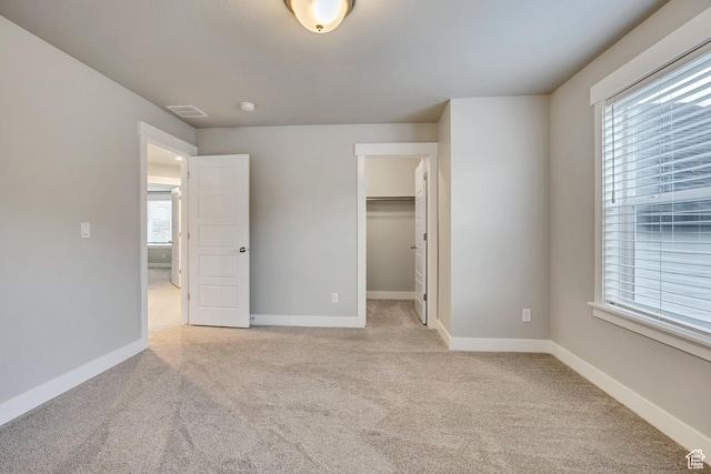 2508 E Lone Hill Dr, Draper Ut Cnty, UT 84020 - unfurnished bedroom with light carpet, multiple windows, a walk in closet, and a closet