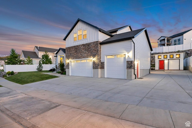 2508 E Lone Hill Dr, Draper Ut Cnty, UT 84020 - view of front of property with stone siding, concrete driveway, board and batten siding, an attached garage, and a garage