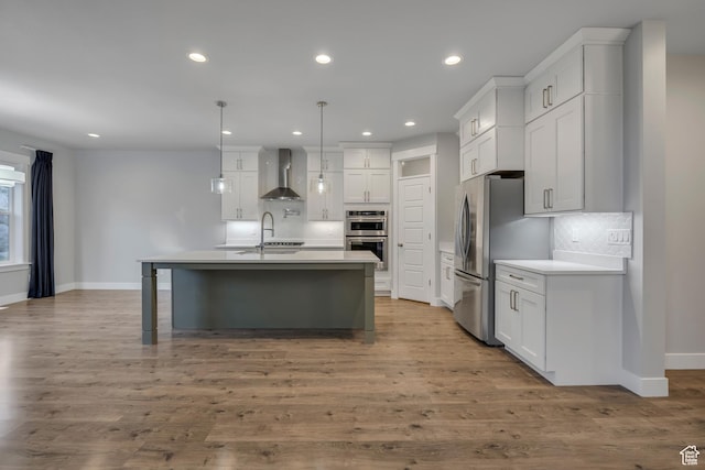 2508 E Lone Hill Dr, Draper Ut Cnty, UT 84020 - kitchen featuring wall chimney exhaust hood, stainless steel appliances, decorative backsplash, a kitchen island with sink, and recessed lighting