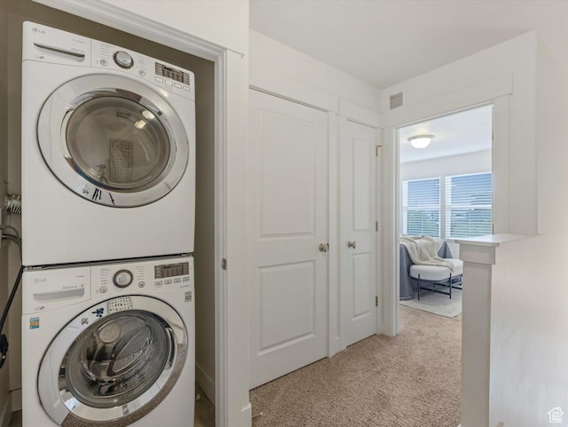 4851 W Daybreak Pkwy, South Jordan, UT 84009 - washroom featuring estacked washer and dryer and carpet floors