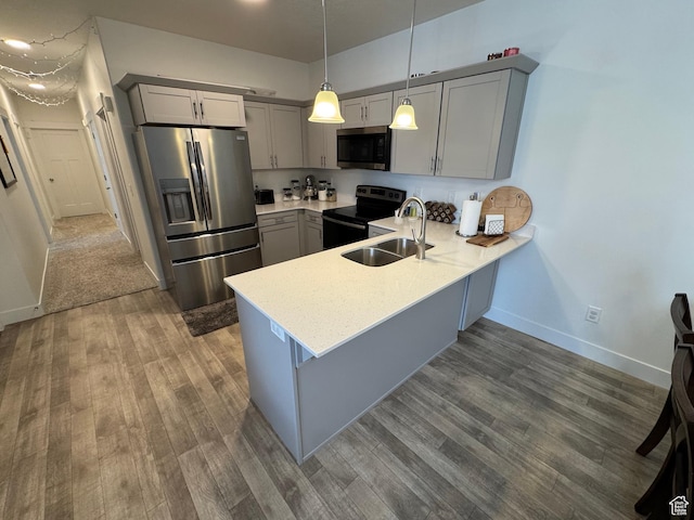 949 W Big Ben Ln Unit I304, Saratoga Springs, UT 84045 - kitchen with appliances with stainless steel finishes, gray cabinets, a peninsula, and dark wood-style floors