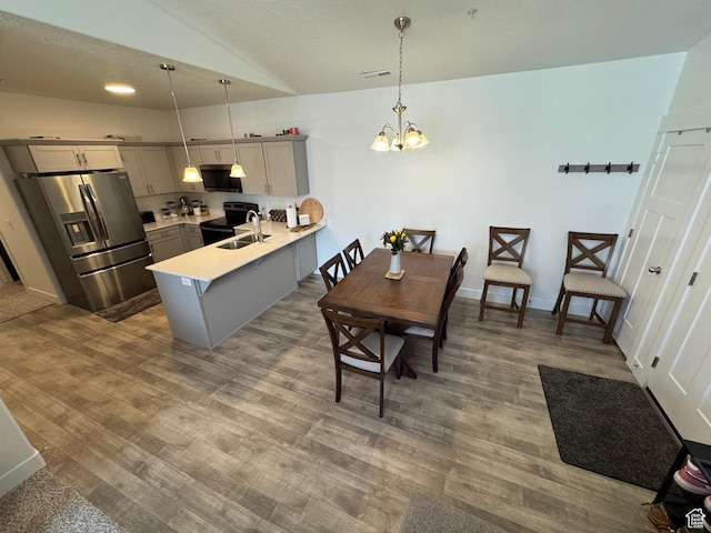 949 W Big Ben Ln Unit I304, Saratoga Springs, UT 84045 - dining room with vaulted ceiling, wood finished floors, and a chandelier