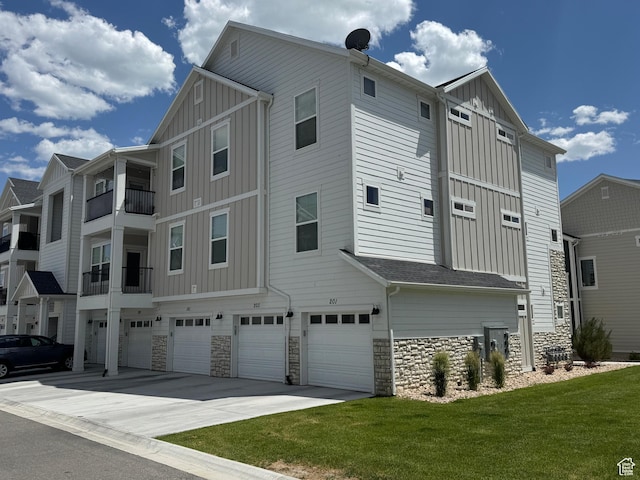 949 W Big Ben Ln Unit I304, Saratoga Springs, UT 84045 - view of side of property featuring board and batten siding, an attached garage, and stone siding