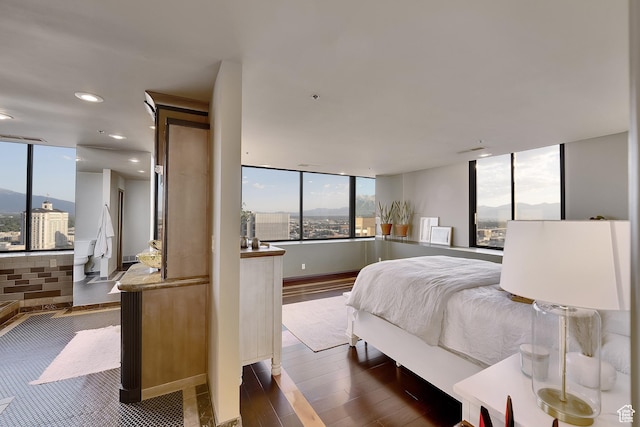 44 W Broadway S Unit 2005S, Salt Lake City, UT 84101 - bedroom with dark wood-style floors, recessed lighting, and expansive windows