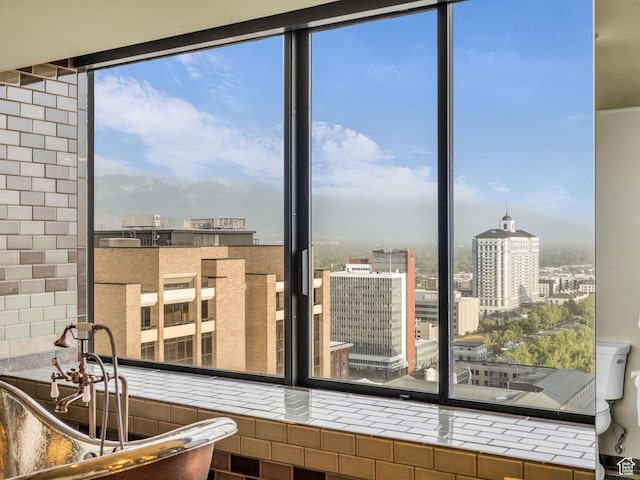 44 W Broadway S Unit 2005S, Salt Lake City, UT 84101 - kitchen with a city view, tile counters, and a wall of windows