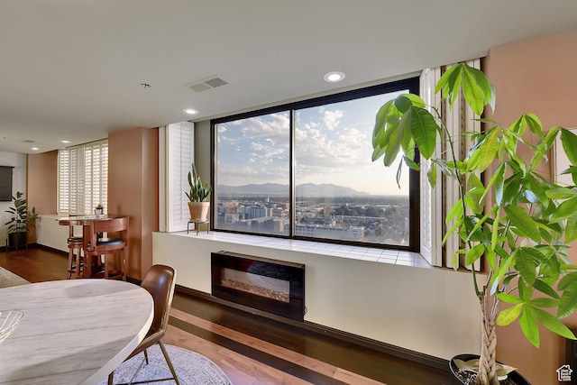 44 W Broadway S Unit 2005S, Salt Lake City, UT 84101 - dining space with wood finished floors, a fireplace, plenty of natural light, a mountain view, and recessed lighting
