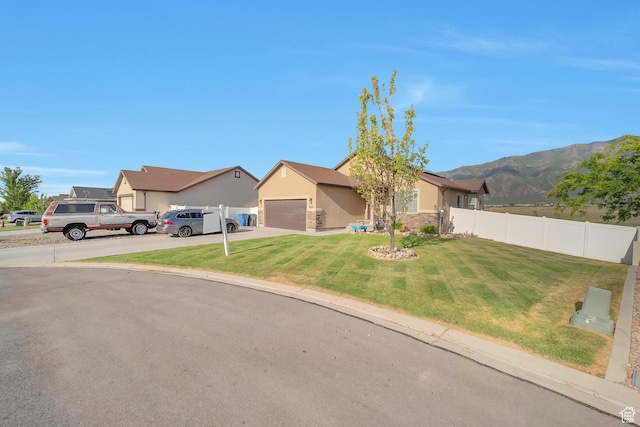 633 Little Rock Dr, Santaquin, UT 84655 - view of front of property featuring concrete driveway, a garage, stucco siding, a mountain view, and stone siding