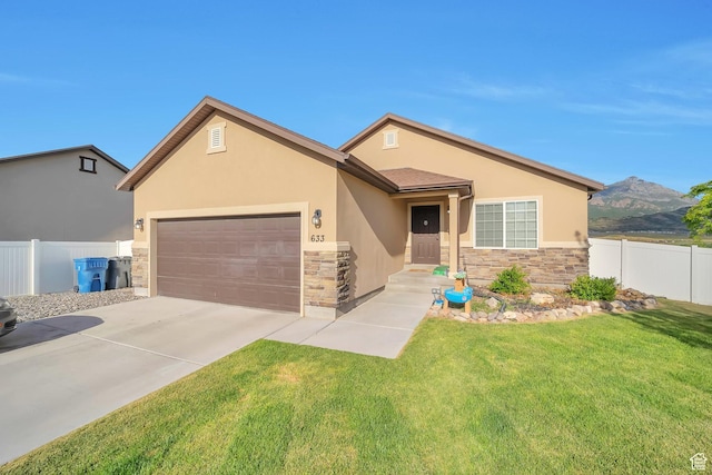 633 Little Rock Dr, Santaquin, UT 84655 - view of front of home with stone siding, stucco siding, an attached garage, concrete driveway, and a mountain view