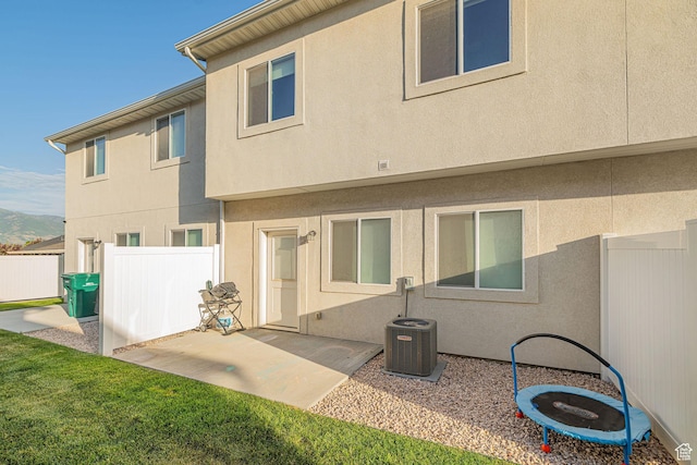 2726 S 2250 W Unit 218, West Haven, UT 84401 - back of property with stucco siding, a patio area, and a mountain view