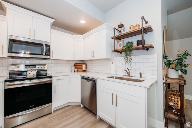 2726 S 2250 W Unit 218, West Haven, UT 84401 - kitchen with stainless steel appliances, open shelves, light wood-type flooring, light countertops, and recessed lighting