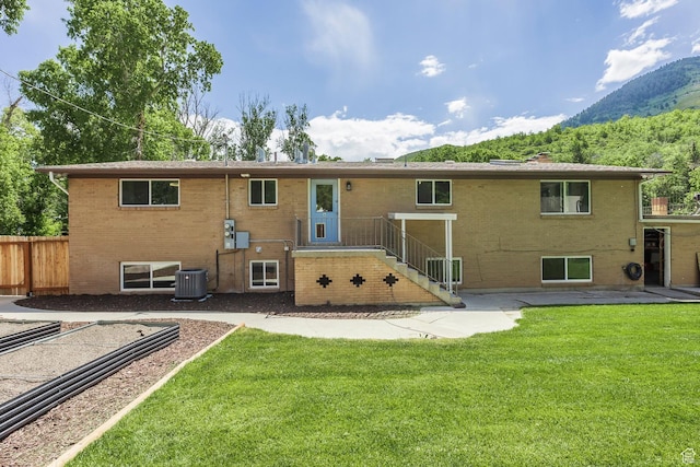 32 S Smokey Ln, Emigration Canyon, UT 84108 - rear view of property with a mountain view, brick siding, a chimney, and a patio