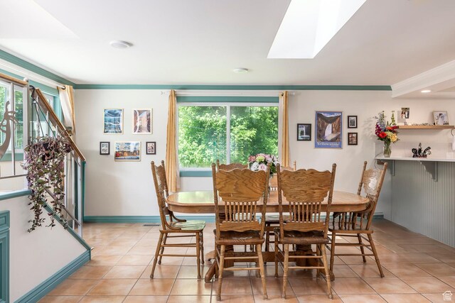 32 S Smokey Ln, Emigration Canyon, UT 84108 - dining area with light tile patterned floors, a skylight, and crown molding