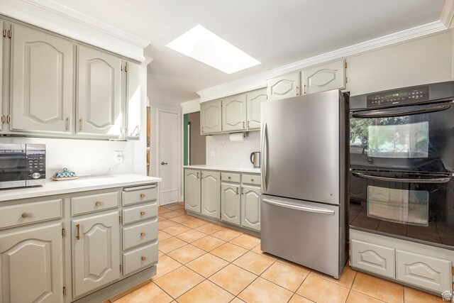 32 S Smokey Ln, Emigration Canyon, UT 84108 - kitchen featuring appliances with stainless steel finishes, a skylight, light tile patterned flooring, light countertops, and crown molding