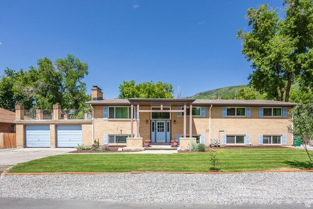 32 S Smokey Ln, Emigration Canyon, UT 84108 - view of front of home featuring driveway, a chimney, a garage, and brick siding