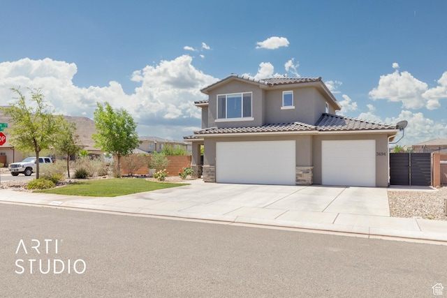 3694 E Tauri Way, St George, UT 84790 - mediterranean / spanish-style house with stucco siding, driveway, a tile roof, stone siding, and a garage
