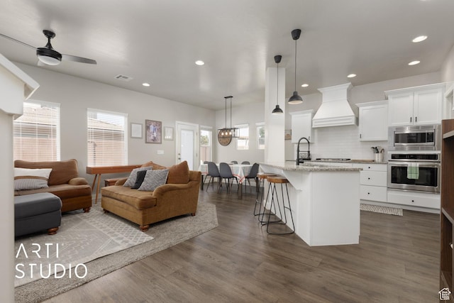 3694 E Tauri Way, St George, UT 84790 - living area featuring plenty of natural light, dark wood finished floors, recessed lighting, a ceiling fan, and a chandelier