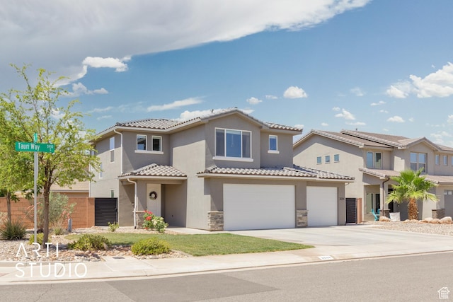 3694 E Tauri Way, St George, UT 84790 - mediterranean / spanish home with a garage, concrete driveway, a tile roof, stucco siding, and stone siding