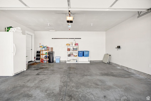824 N 980 W, Tremonton, UT 84337 - garage featuring freestanding refrigerator and a garage door opener