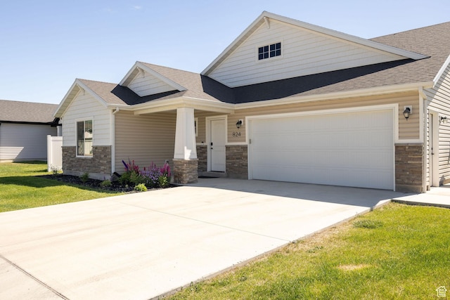 824 N 980 W, Tremonton, UT 84337 - craftsman-style home featuring stone siding, concrete driveway, roof with shingles, an attached garage, and covered porch