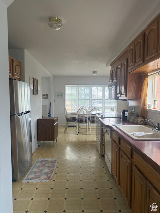 388 N Main St, Monticello, UT 84535 - kitchen featuring freestanding refrigerator, plenty of natural light, dishwasher, and dark countertops