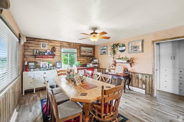 1665 E 1200 N, Mount Pleasant, UT 84647 - dining space with light wood finished floors, a ceiling fan, wood walls, and a wainscoted wall
