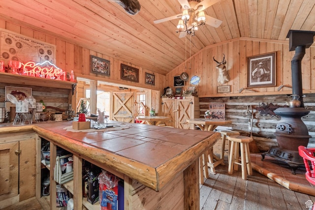 1665 E 1200 N, Mount Pleasant, UT 84647 - dining space with vaulted ceiling, wood walls, wooden ceiling, hardwood / wood-style floors, and a ceiling fan