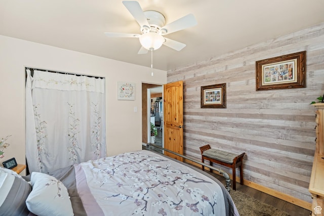 1665 E 1200 N, Mount Pleasant, UT 84647 - bedroom featuring wooden walls, an accent wall, wood finished floors, and ceiling fan
